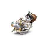 Statuina Krishna On Leaf Lladrò in porcellana opaca con dettagli oro 15x21 cm