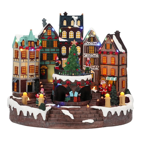 Paesaggio natalizio città Timstor con luci LED e albero rotante 31x27,5 cm
